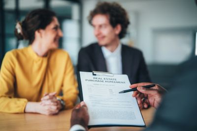 Couple reviewing a real estate purchase agreement.