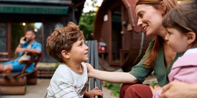 Mother talking to her kids outdoors.