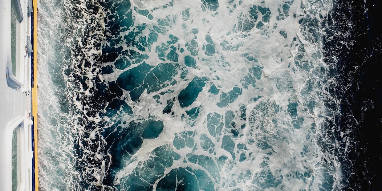 View of ocean waves from a boat side.