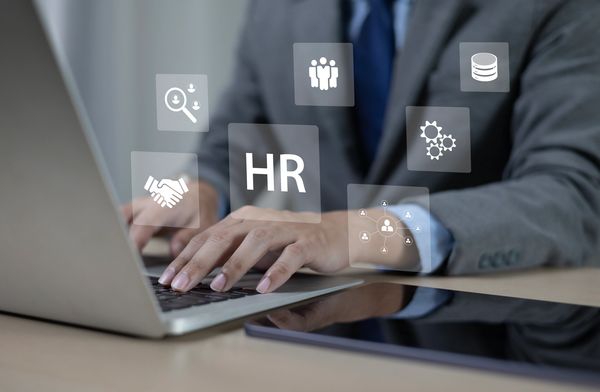 Person working on HR tasks with digital icons.
