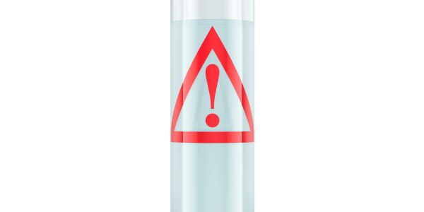 Tube of liquid with red caution symbol.