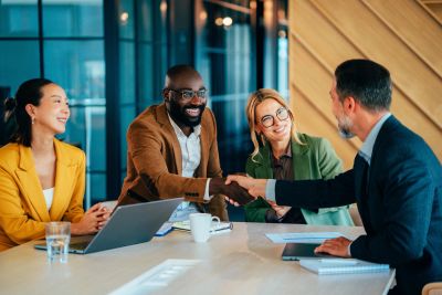 Business people shaking hands during a meeting.
