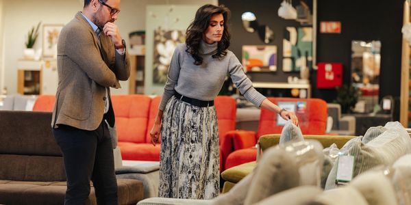 customers shopping for furniture in a modern showroom.