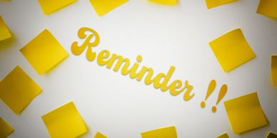 Yellow sticky notes surrounding the word Reminder.