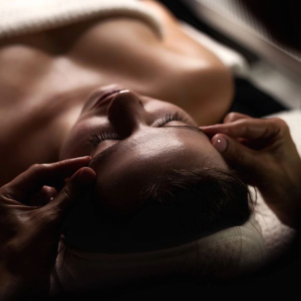 Person receiving a facial massage.