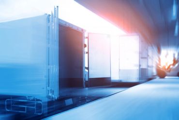 Open shipping container in a bright warehouse.