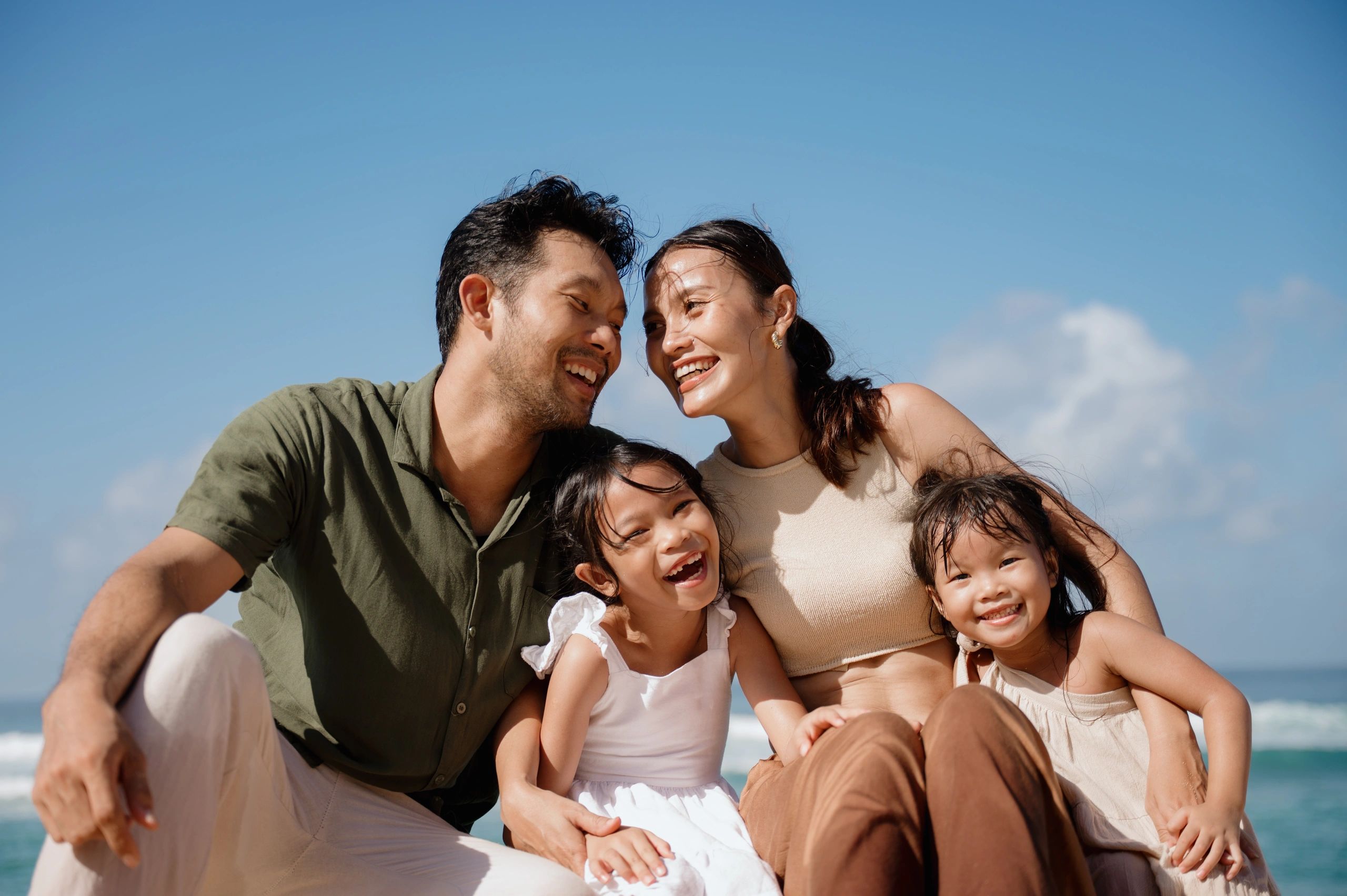 Happy family enjoying a sunny day at the beach.