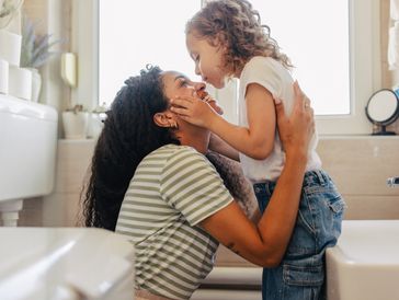 Mother and daughter looking at each other, smiling.