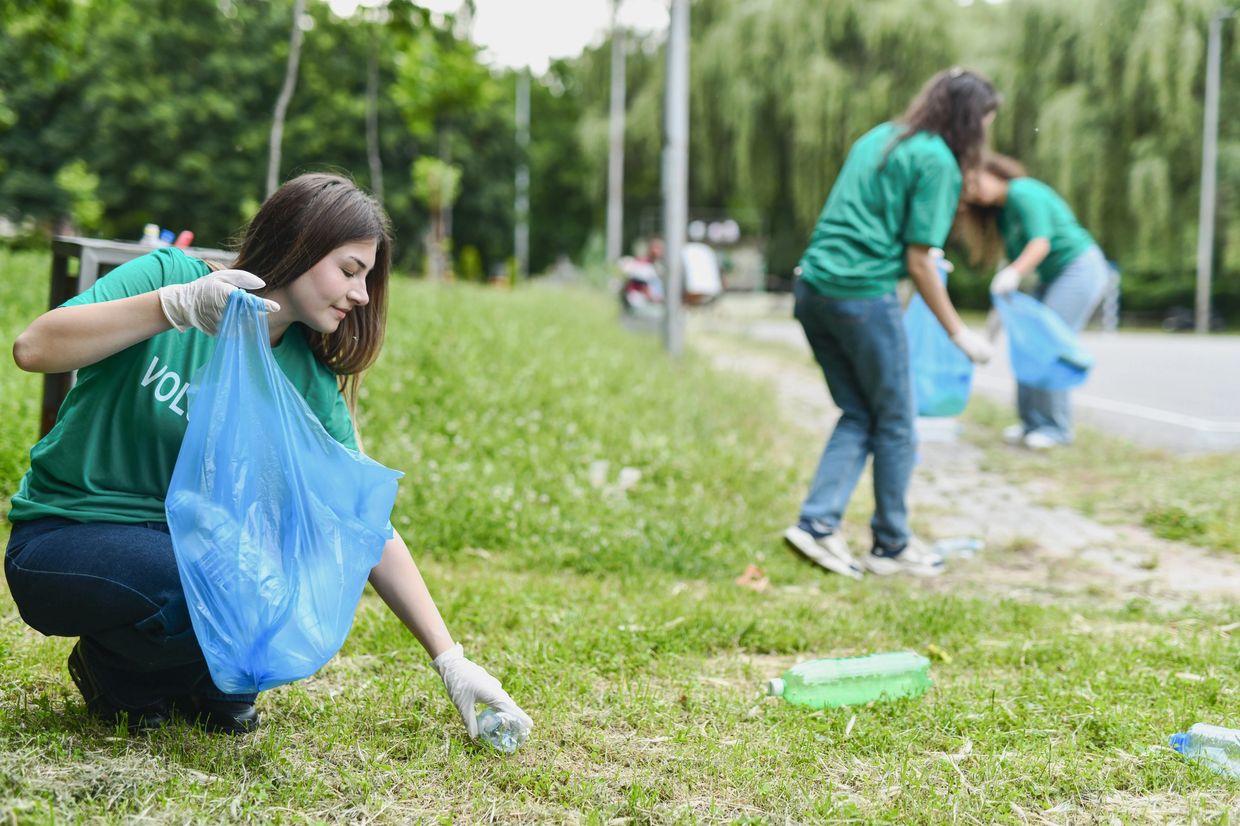 Volunteers picking up litter in a park.
