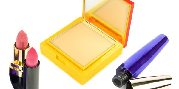 Makeup products including lipsticks, compact powder, and mascara.