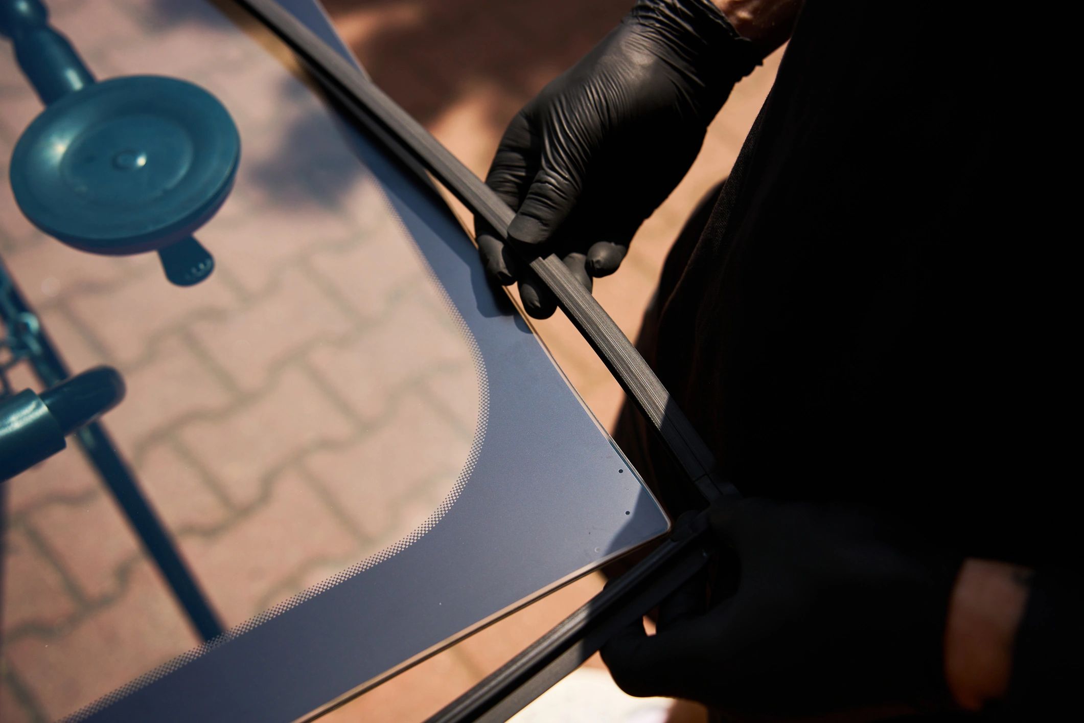 Auto glass repair technician working on a windshield