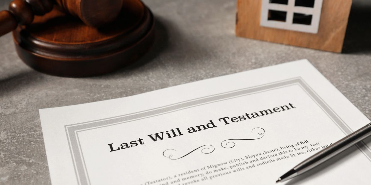 A last will and testament document with a pen and gavel.