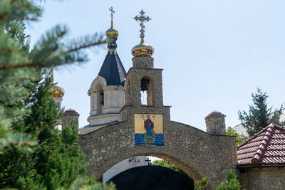 Stone archway with religious crosses and icon.