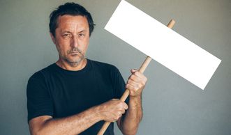 Man holding a blank protest sign.