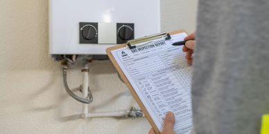 Person filling out a gas inspection report near a boiler.