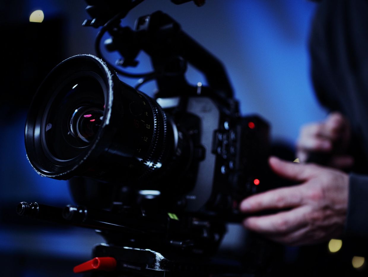 Close-up of a professional video camera being operated.