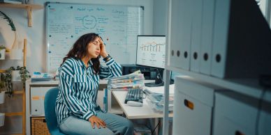 Stressed woman working late in an office.