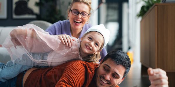 Family laughing and playing together at home