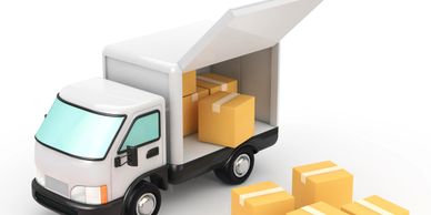 A delivery truck with its back open and several cardboard boxes outside.