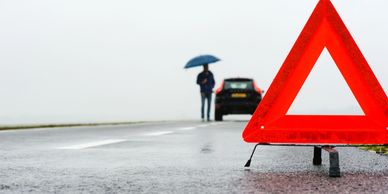 A Traffic Board With A Ham Holding An Umbrella With A Car