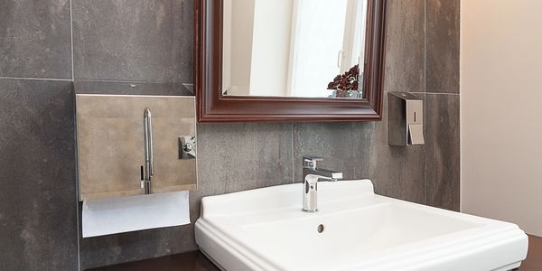 Custom bathroom vanity with marble wall accents.