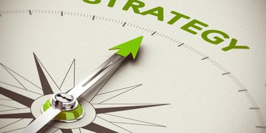 Compass needle pointing towards the word 'STRATEGY' in green.