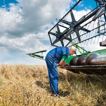 man fixing a combine harvester
