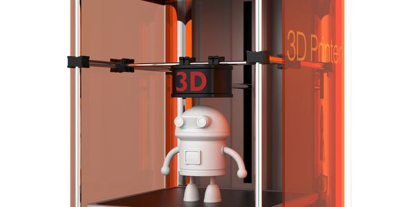 3D printer creating a small robot model inside an orange enclosure.