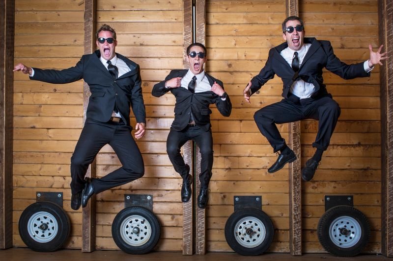 Three crazy businessmen jumping.