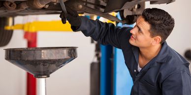 Mechanic performing oil change service at Busy Boots Automotive in Las Vegas.
