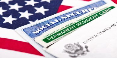 US flag with Green Card and Social Security Card.