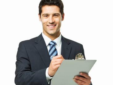 Smiling businessman holding a clipboard and pen.