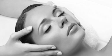 Woman enjoying a relaxing facial massage at a spa.