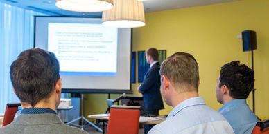 A group of people looking at a presentation