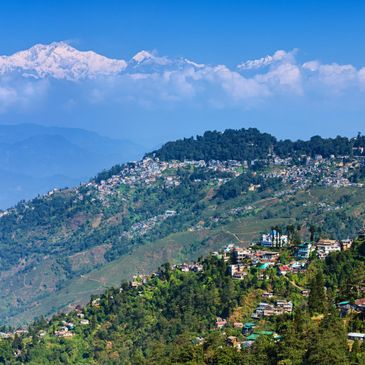Scenic mountain town with snow-capped peaks and clear blue sky.