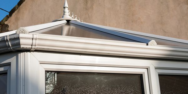 Close-up of a white conservatory roof with droplets on the window.