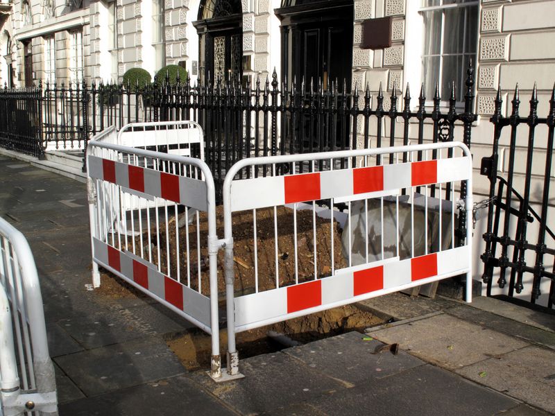 Unfinished roadworks on a pavement in a fashionable London district