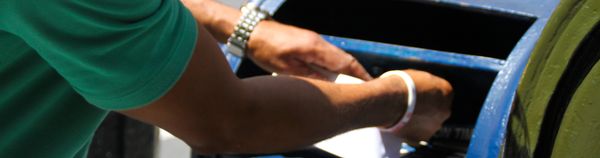 Hands inserting a card into a machine.