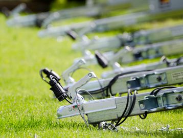 Row of trailers on grass field.