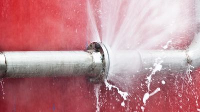 Pipe bursting and water spraying out.