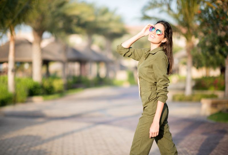 Beautiful model in jumpsuit fashion walking down the beach boulevard. Nikon D810. Converted from RAW.