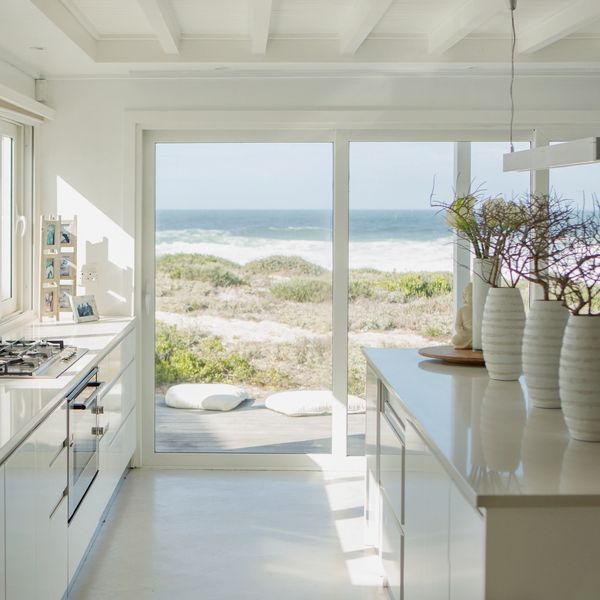 Bright modern kitchen with ocean view and minimalist decor.