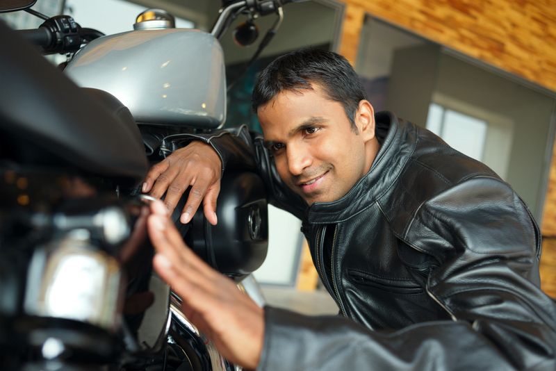 Man looking with admiration at his motorbike