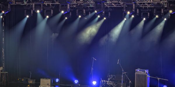 Empty stage with musical instruments and lighting setup ready for a performance.
