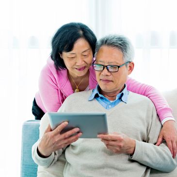 Elderly couple using a tablet together at home.