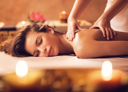 A woman enjoying a relaxing back massage in a serene spa setting.