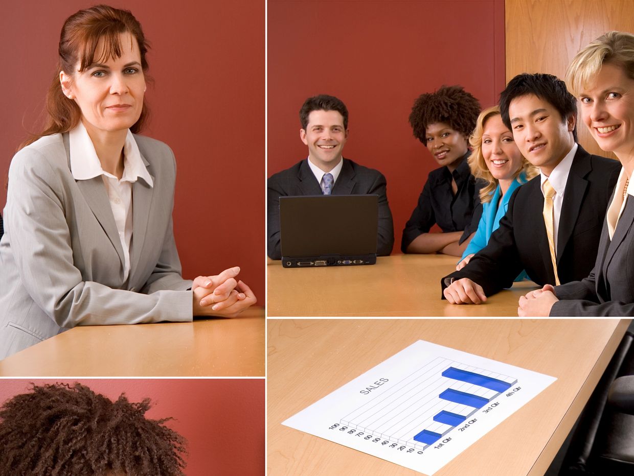 Diverse business team in a meeting with sales chart and laptop.
