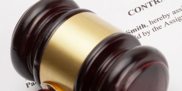 A judge's gavel resting on a legal contract document.