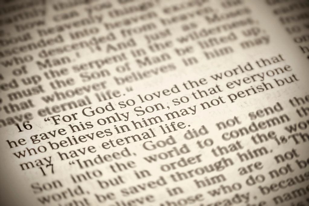 Close-up of Bible verses about God's love and eternal life.
