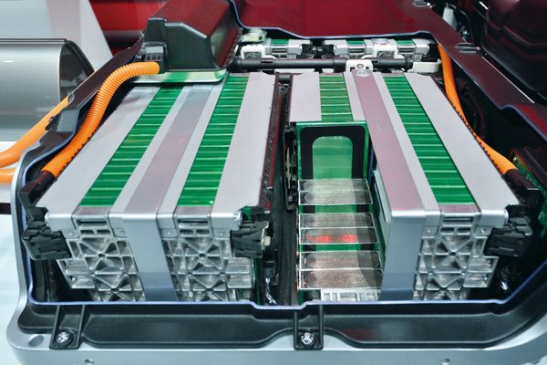 Inside view of a modern electric vehicle battery pack with cells and wiring.